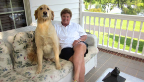 Debbie Clay and her golden retriever relaxing on their front porch.