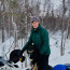 Donna Massay on her snow machine with her dog 